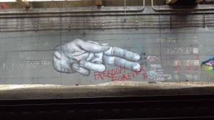 The most widespread method of retaliation against graffiti writers by authorities is the removal of their works. Amtrak has actively buffed out, or painted over, the plethora of pieces in the Freedom Tunnel, such as this famous Coca-Cola/"The American Dream" mural created by Freedom. As a retort, he wrote a new piece over the old one. Photo taken with a Canon PowerShot SX150 IS.
