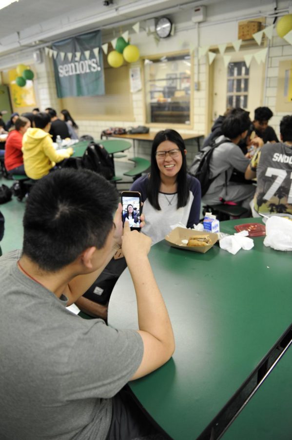 Students try out the new Snapchat feature on their phones.