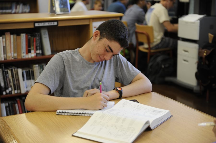 Morgan Krell 18 keeps on top of his coursework during his senior year by taking the time to complete homework in the school’s library. 