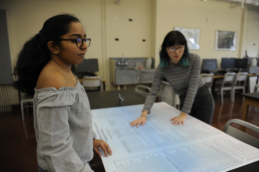 Uma Balachandran 18 and Alexandria Ang 18 work on poster presentations 
for their Senior Research Poster Session.