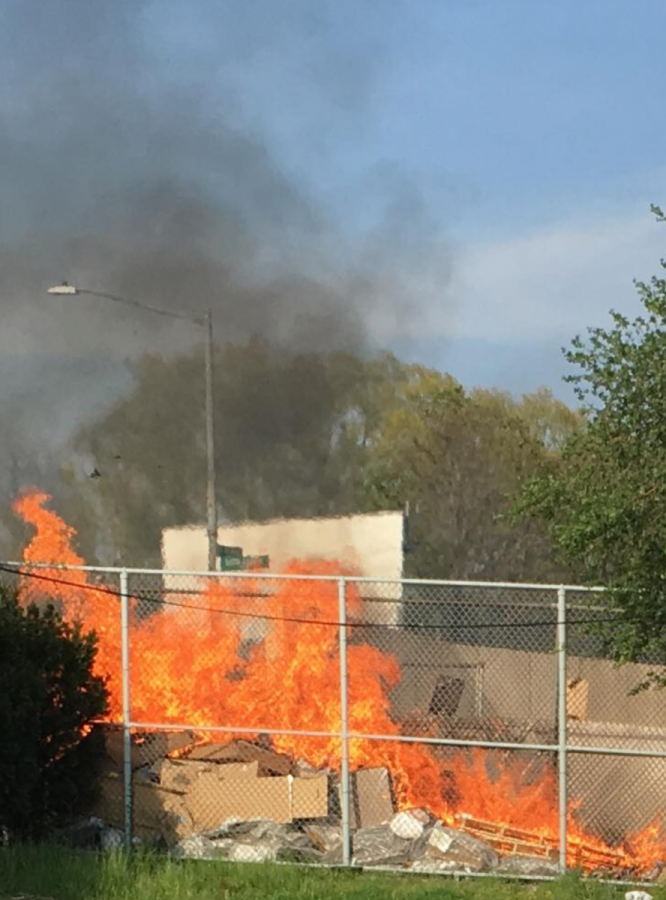 The fire quickly spread through the gated-in pile of trash.
