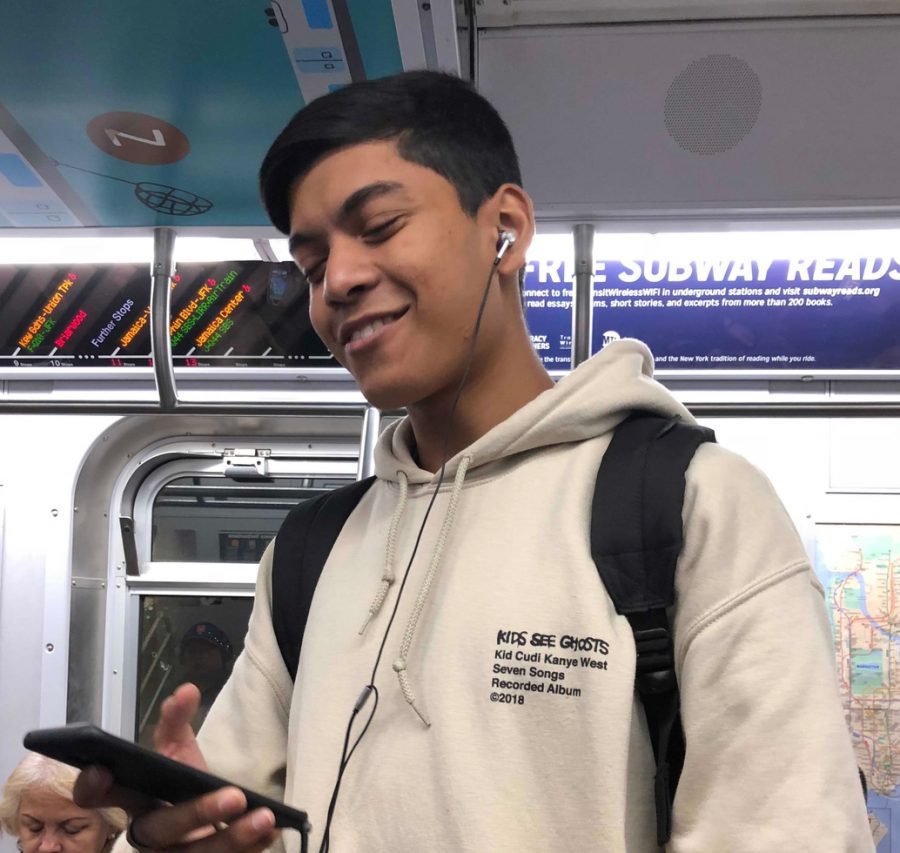 Semanto Khan ‘20, a student from Stuyvesant High School, stays updated on the news surrounding Kanye as he scrolls through his Instagram feed. His hoodie is one of the many Kanye pieces that he owns.
