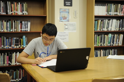 A student spends his free period studying diligently in the library, with the end goal of college acceptance.