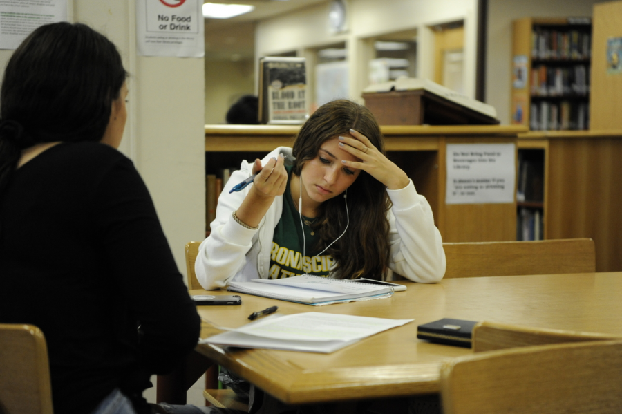Ellie Selden 21 focuses intently on her work in the library.