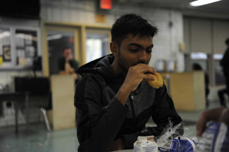 Rahil Ahmed ’20 eating bread, the portion of his school lunch that does not have meat. 
