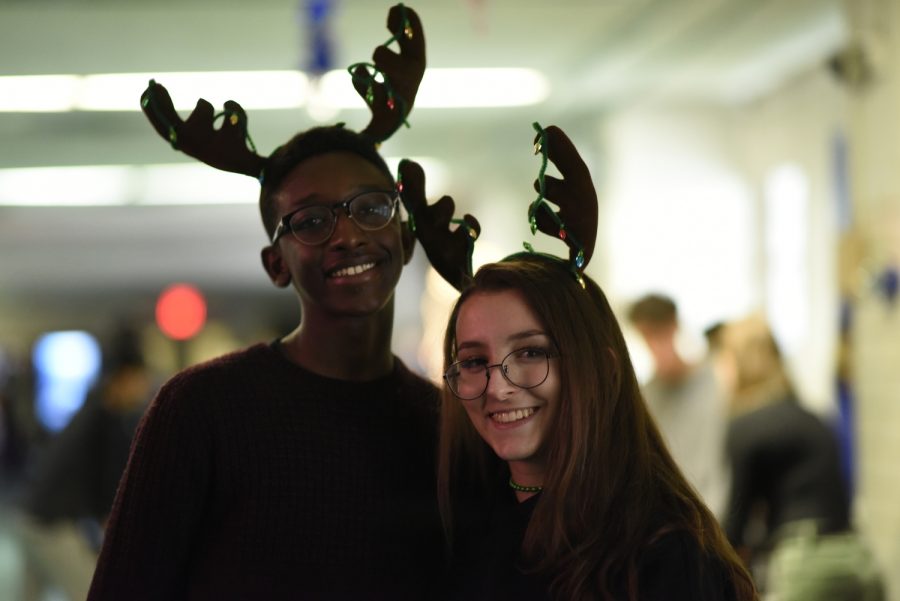 Seniors Li Chai Epperson and Chloe Frajmund in the Christmas spirit as they pose wearing reindeer antlers.