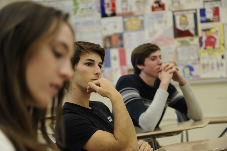 Sophie Zinberg 19, Will Fisher 19, and Pietro Topa 19 listen intently to opinions on Nancy Pelosi as Speaker of the House, which was discussed during a Current Events Forum meeting.