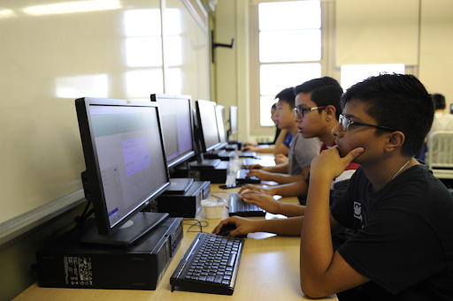 Students in a Coding for All class run programs in the computer lab.
