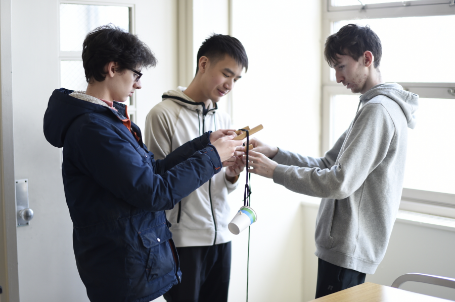 Daniel Belkin ’23, David Guo ’19 and Michael Heege ’19 ensure that their project is ready for the build event Boomilever.