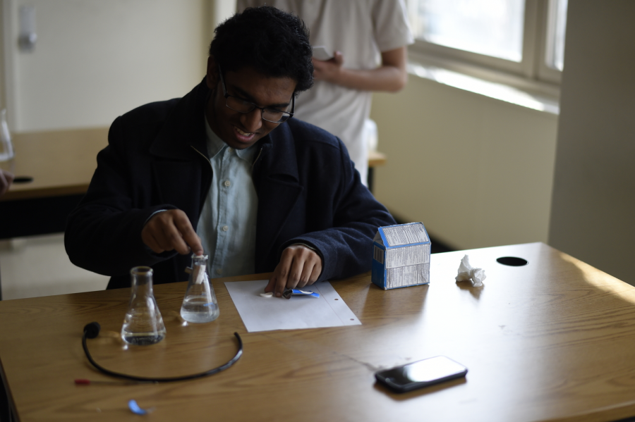 Dion Sukhram ’19 puts together a device where alka-seltzer would be used to push a golf ball off a ramp for the event Mission Possible.