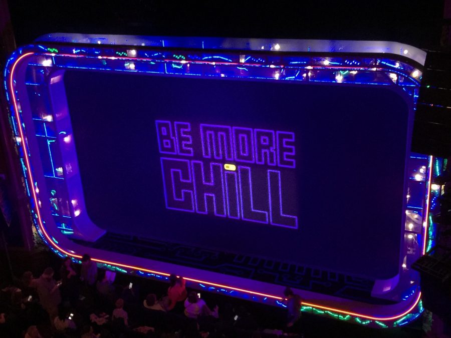 The Be More Chill musical displays this screen covering before the start of the show and also during intermission. However, the pill on the “i” is gray at first and changes to yellow during the intermission, indicating the activation of the “SQUIP”