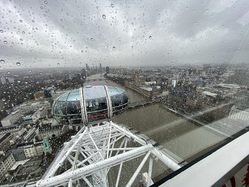 Poritzky peers over the city known as The Big Smoke from the London Eye. Water droplets on the window enliven the gloomy cityscape.