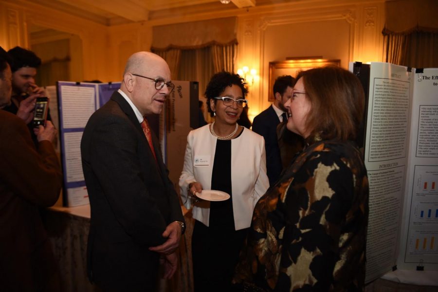 Dr. Donahue and her husband discuss the research projects with Dr. Jill Bargonetti on the night of the research competition. 