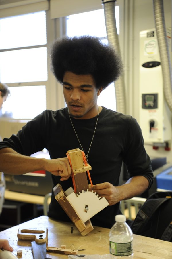 Kiyro Flamer-Caldera '20 puts the finishing touches on his engineering project.