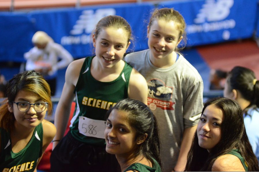 Ninth graders smile for the camera at the annual Martin Luther King track meet. “I enjoyed the moments that we had at the armory which contrasted with cross country,” said Chloe Chan ’23 who ran the 600m and 3000m in indoor track.