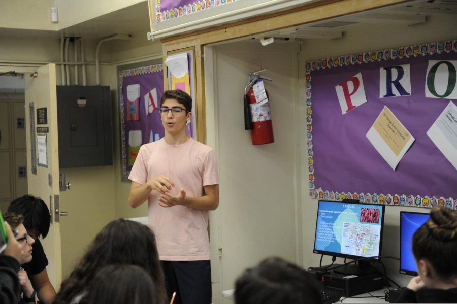 A student presents his work from his computer in Spanish class.
