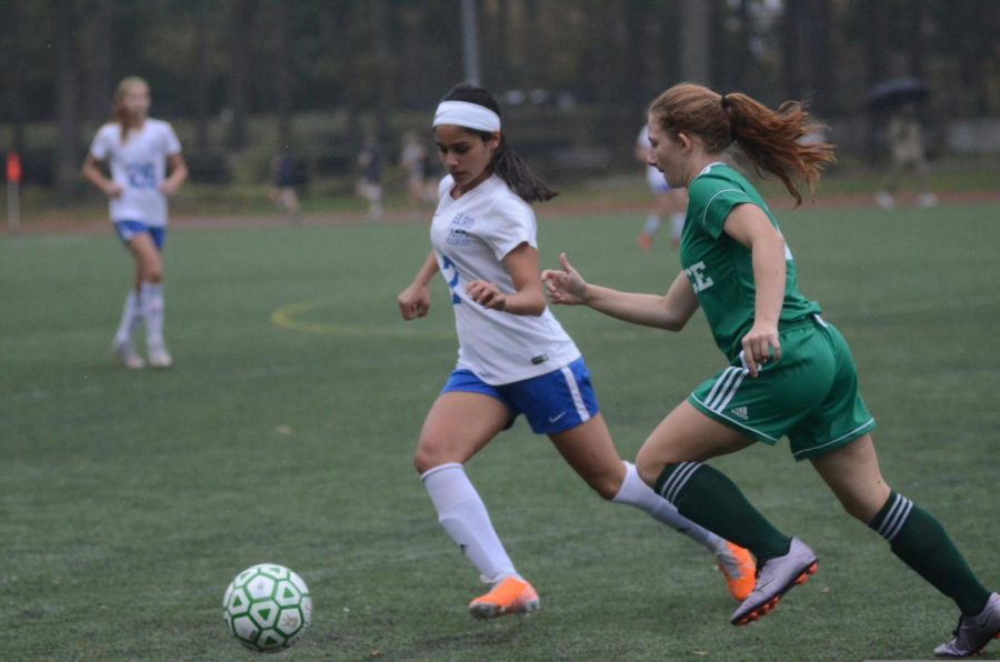 A student on the Girls’ Varsity Soccer team runs to steal the ball.