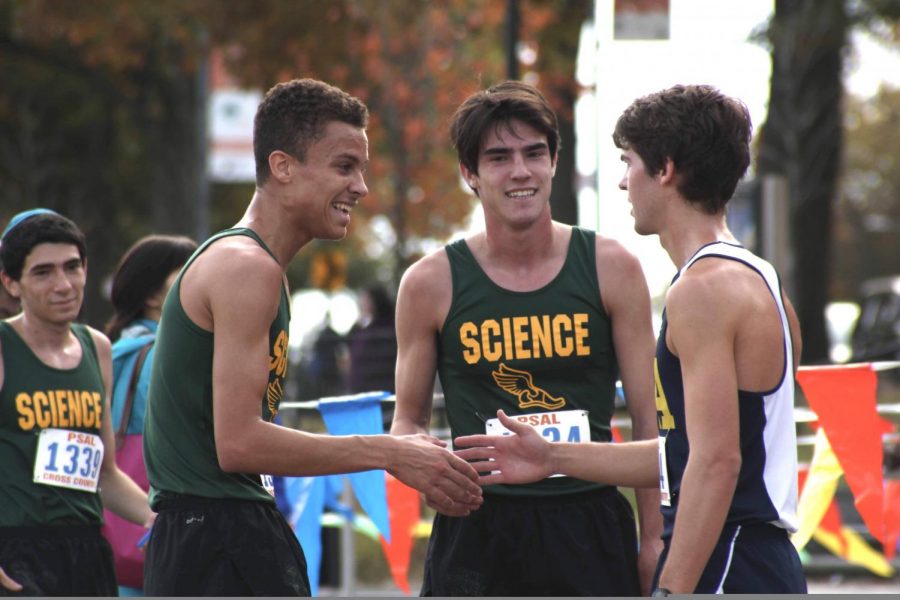 Nate Lentz 20 and his friends smile after a Boys Varsity Cross Country meet. 
