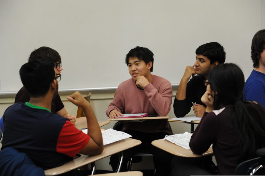 Students from the Bronx Science Dungeons & Dragons club are discussing game strategy during a club meeting earlier in the 2019-2020 academic year. 