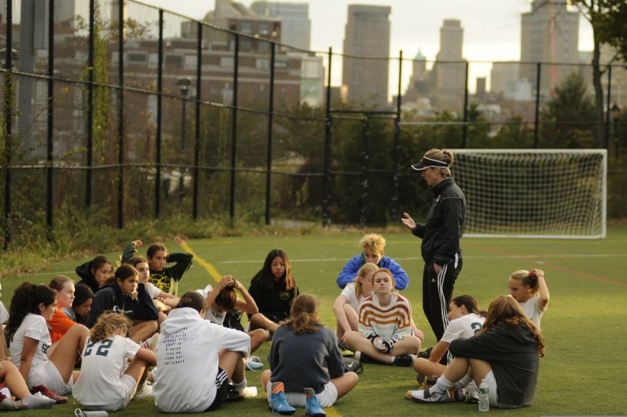 Members of the Girls’ Varsity Soccer team sit together on the field during a practice. Huddles and group meetings like these are essential to the game, but with the pandemic, leagues must consider all of the potential ways to limit player contact.