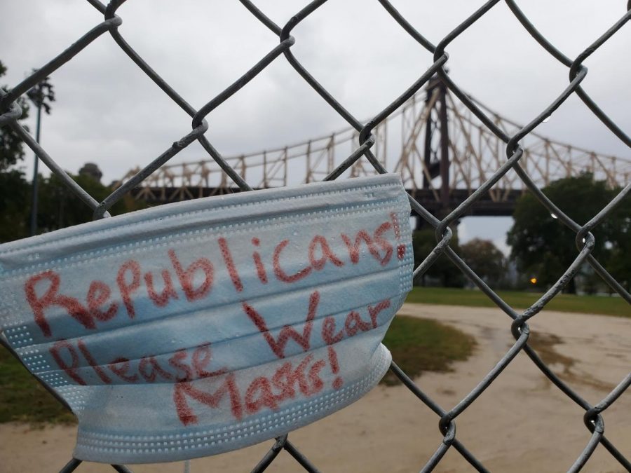 A mask with writing noting ‘Republicans! Please Wear Masks!’ is strung up on Queensbridge Park in Long Island City in Queens, New York. The mask is in an open space for all of the public to see. 