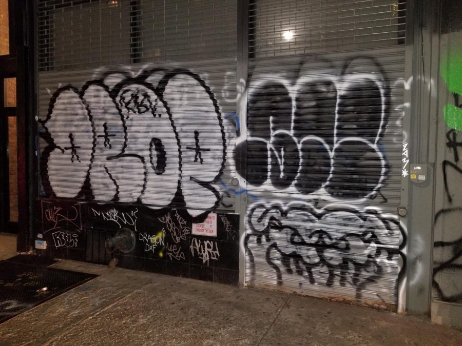 New York Citys storefront gates are baptized by spray paint through local graffiti taggers.