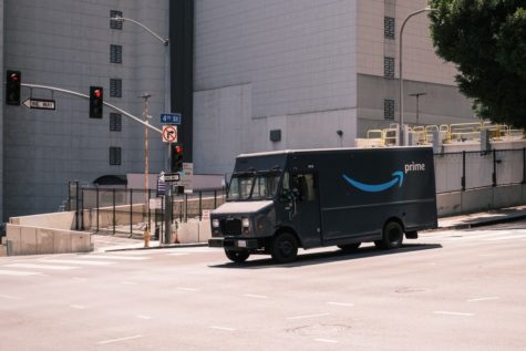 An Amazon driver in Los Angeles works to complete his deliveries. 