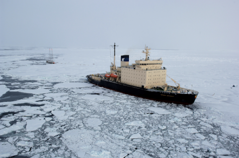 A Russian icebreaker ship powers through the Arctic water.