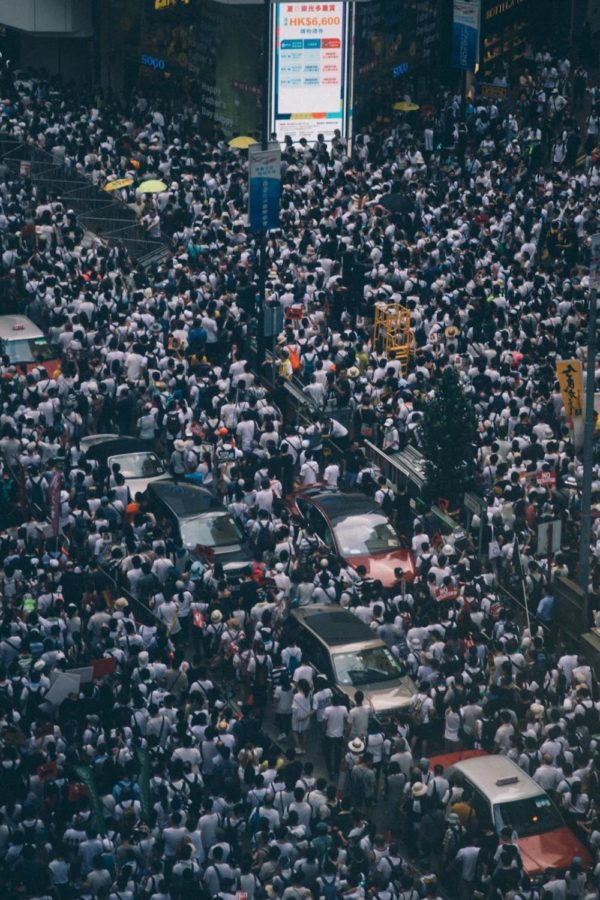 Hundreds make their way down a packed street in Hong Kong, which currently has a population of around 7.76 million. That statistic is slated to grow to around 8.2 million by the 2040s, before declining to 7.72 million by 2066.

