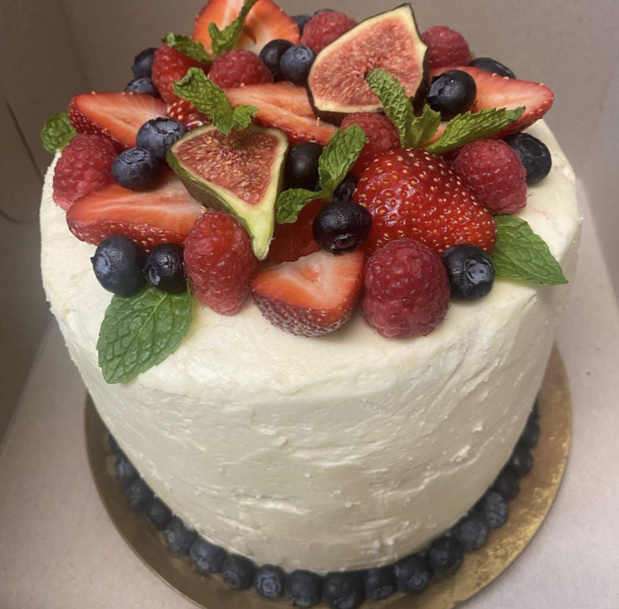 Pictured+is+a+chocolate+cake+with+vanilla+buttercream%2C+topped+with+berries%2C+figs%2C+and+mint.%0A