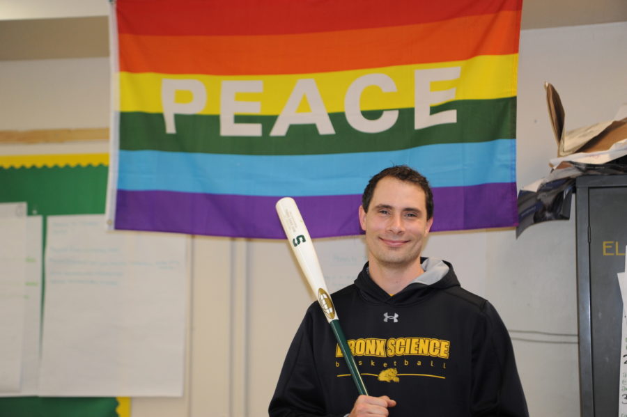 In his Health class, Mr. Dahlem poses with a baseball bat in front of a Peace sign, a representative image of his personality and teaching style.