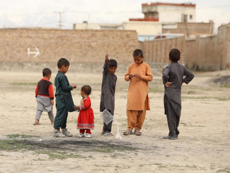 A+group+of+children+dressed+in+red+and+gray+play+in+Kabul%2C+Afghanistan.+This+photo+was+taken+on+October+7th%2C+2020%2C+a+full+year+before+the+Taliban+resurgence.+During+this+time%2C+tensions+between+the+US+and+the+Taliban+rose+once+more%2C+with+Taliban+attacks+increasing.