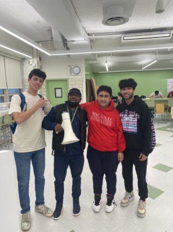 Mr. Ogilvie poses with some students in the cafeteria. From left to right: Ben Golden 22, Mr. Ogilvie, Jatin Kapoor 22, and Rayaan Rahman 22.