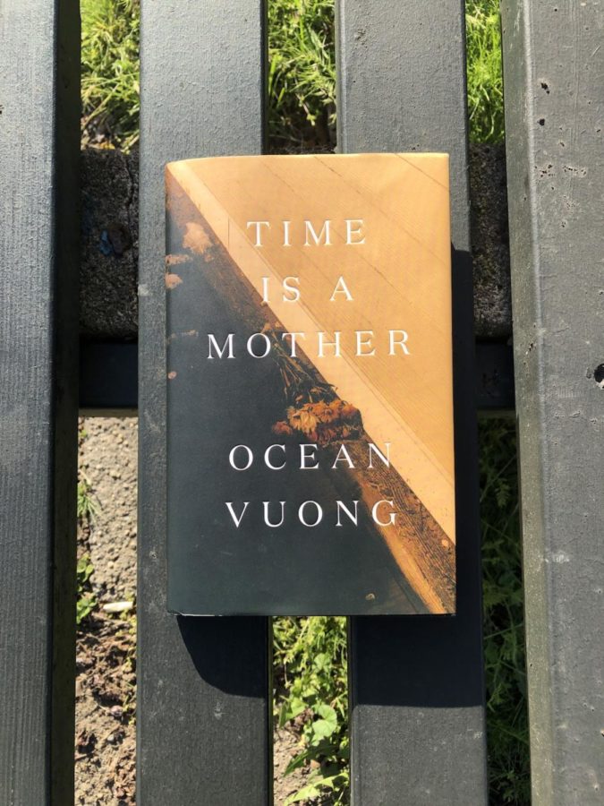 Perhaps in its most natural element, a copy of the book Time Is a Mother sits on a park bench unassumingly.