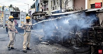 Firefighters put out a street fire during the 2020 Bangalore Riots, caused by an alleged blasphemous Facebook post by the nephew of an Indian National Congress state legislator targeting the Islamic Prophet Muhammad. Damages in the resulting chaos included looting, the burning of cars and police stations, three deaths, and the arrests of over 206 people.