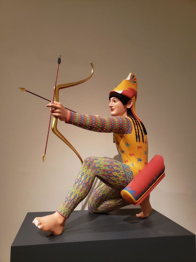 Here is a reconstruction of a marble archer, from the north and east of Greece. An intricate and vibrantly painted archer kneels to aim a gold-tipped arrow. For this much detail to appear on the sculpture, significant color remains were required.