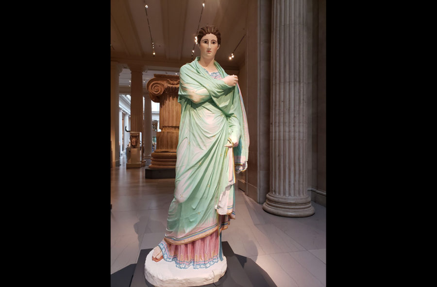 Here is the polychromy reproduction of ‘Small Herculean Woman,’ depicting a woman in a sheer teal shawl. Her gaze follows the viewer with a solemn expression.