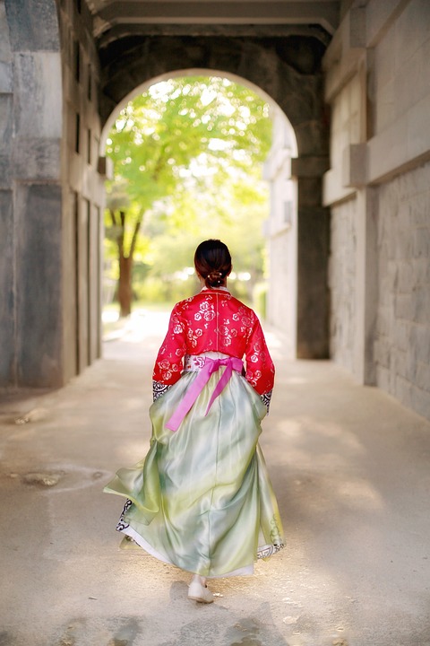 Here is a person wearing a hanbok, which is a traditional Korean clothing typically worn during special occasions or holidays. For instance, children wear hanboks on their first birthday and adults wear hanboks on wedding or funeral days. 