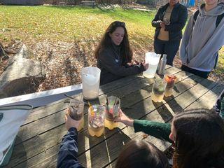 Students compare their water filters in an activity led by Cross River Reservoir educator Jessica Alba modeling the natural water filtration trees perform.