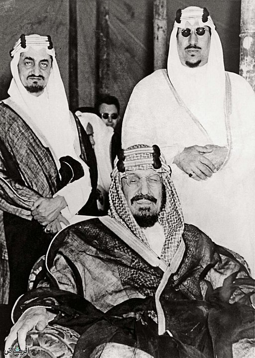 King Abdulaziz (seated), and his sons Saud (Right) and Faisal (Left) pose for a photo together, during Abdulaziz’s reign. 