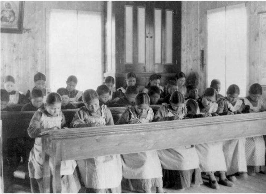 Students at a Residential School in Canada. The identical uniforms and hairstyles in this photo reflect the conformity taught at these institutions. 