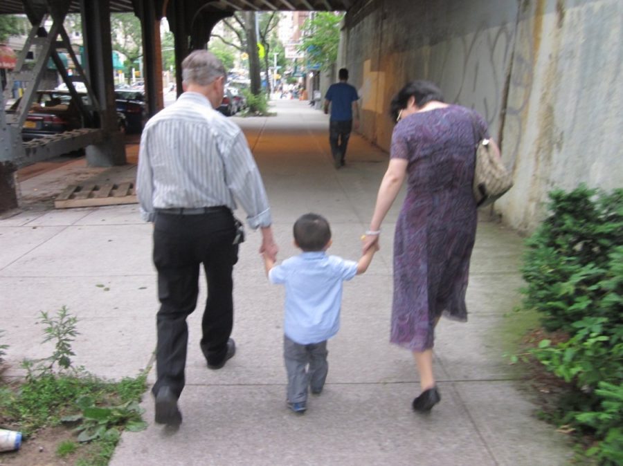My grandparents walk hand-in-hand with my younger brother, enjoying  a breezy spring day in the early 2010’s.