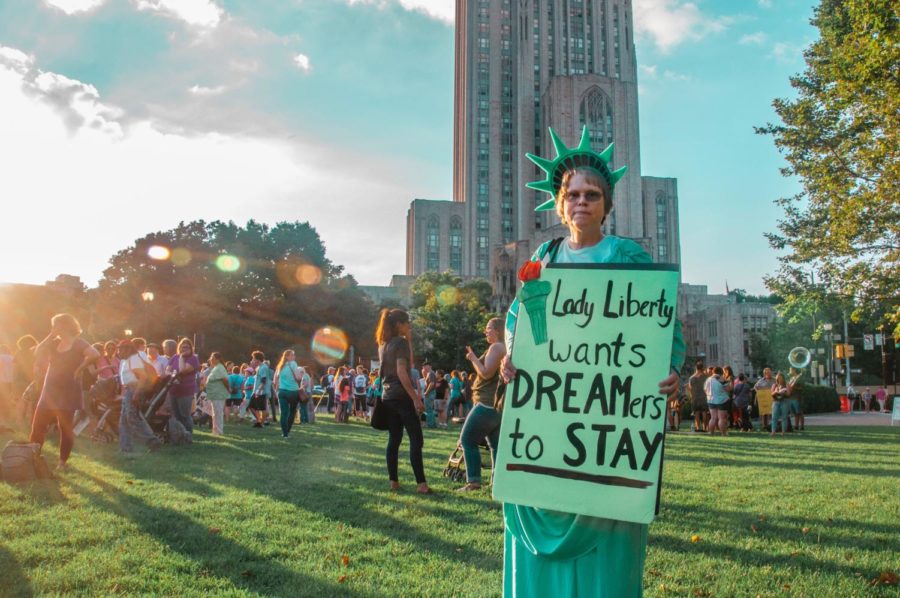 A woman advocates for immigrants to be allowed to be citizens in the United States, while dressed up as the Statue of Liberty.
