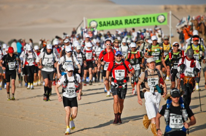 Hundreds of ultramarathoners gather to compete in the Sahara Race, the annual 50 Kilometer footrace held in Egypt. (Photo Credit: John Doe, CC BY-SA 3.0 , via Wikimedia Commons) 
