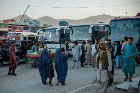 The Kabul streets still echo with life, as groups of people congregate and street vendors continue selling fruit.