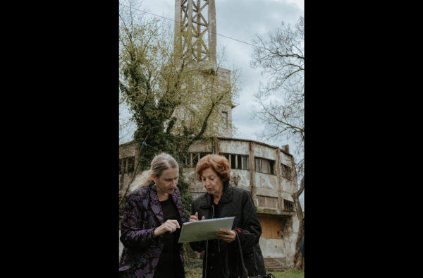 Belgrade, Serbia, July 2022: At the site of the Staro Sajmiste concentration camp, Ellen Germain (at left) talks to the director (at right) about the plans to create a memorial and museum at the site. (Photo provided by Ellen Germain)