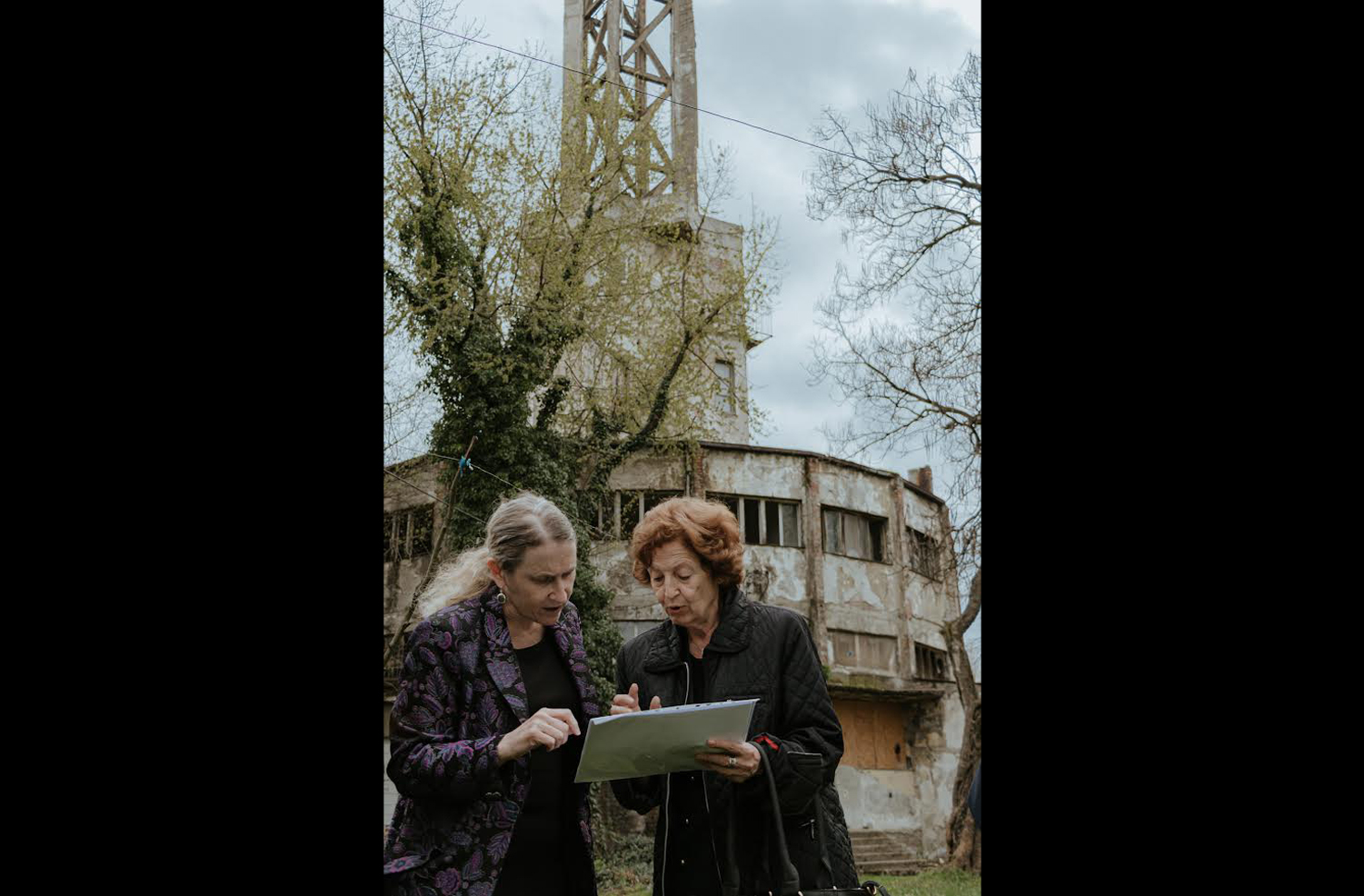 Belgrade, Serbia, July 2022: At the site of the Staro Sajmiste concentration camp, Ellen Germain (at left) talks to the director (at right) about the plans to create a memorial and museum at the site. (Photo provided by Ellen Germain)