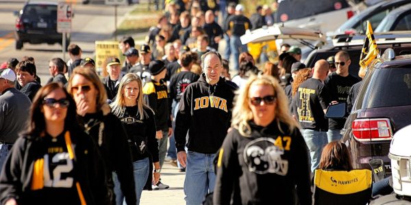 Crowds pour into the stadium from a tailgate at an Iowa football game. College football gameday in America routinely pulls in massive crowds, with ticket prices for top games at up to $500. (Phil Roeder from Des Moines, IA, USA, CC BY 2.0 , via Wikimedia Commons)