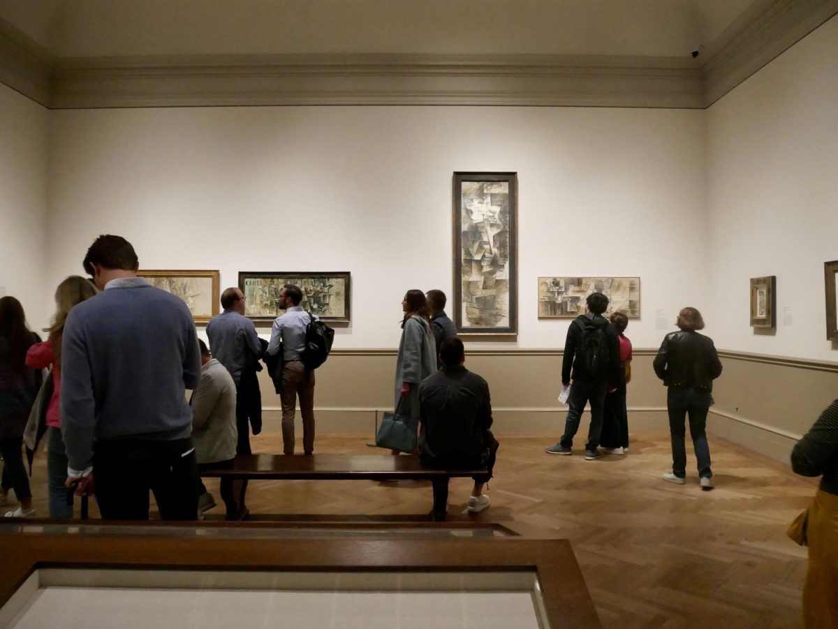 Visitors at the Metropolitan Museum of Art appreciate four of the six finished panels in the exhibition Picasso: A Cubist Commission in Brooklyn.