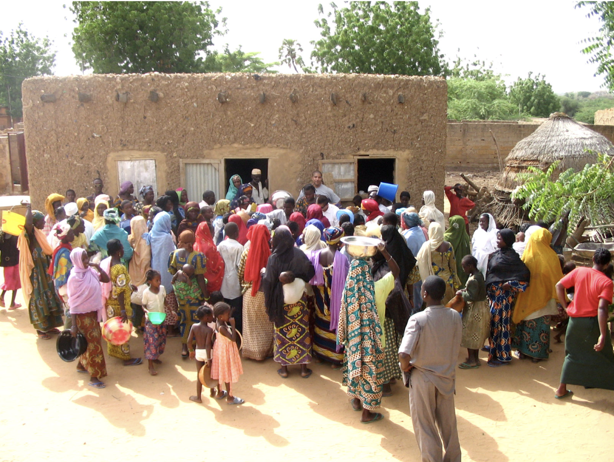 Villagers from Karadje, Niger line up in front of food distribution centers, eager for essential survival supplies. According to the United Nations World Food Programs estimates, more than 1.9 million people in Niger were affected by severe food insecurity in 2020. Another 1.5 million are estimated to be chronically food insecure, and millions more experience periodic food shortages during the lean season. (Photo Credit: US AirForce, Public domain, via Wikimedia Commons) 

